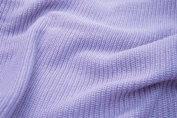 Knitted textured handmade knitted fabric. Lilac abstract background.