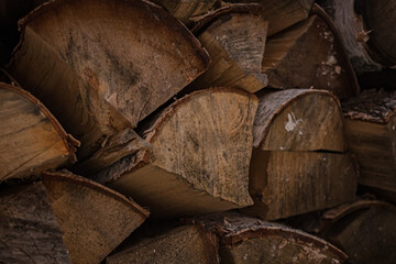 Heating the house in winter. A stack of wood. Firewood from chopped birch. Heat the stove. Chopping firewood. Warm house.