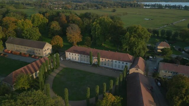 German Paretz manor with front yard cypresses. Gorgeous aerial view flight drone