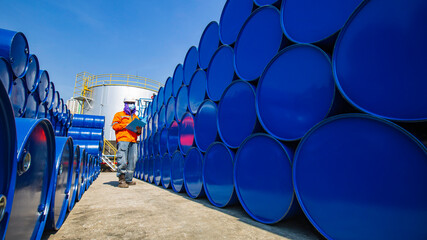 Male worker inspection record drum oil stock barrels blue horizontal or chemical