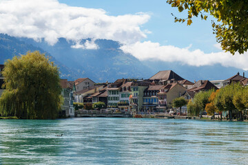 The town of Interlaken viewed from the river, with mountains in the background