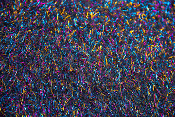 Blurry defocused multicolored sparkling fabric surface as texture background