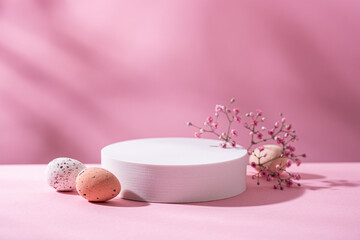 Fototapeta na wymiar Abstract empty white podium with with Easter quail eggs and shadows on pink background. Mock up stand for product presentation. Minimal concept. Advertising template