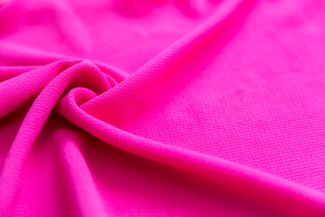 Bright pink magenta folded fabric textile as texture background