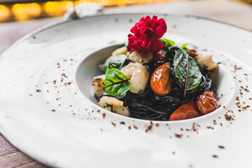 Black Tangliolini with Shrimps modern cuisine with seafood. High quality photo
