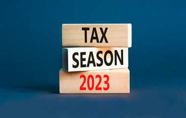 Tax season 2023 symbol. Concept words Tax season 2023 on wooden blocks on a beautiful grey table...