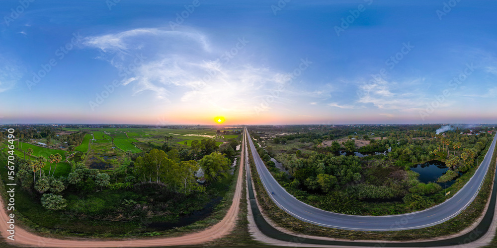 Wall mural 360 degree high angle view of a two-lane road. there are two sides of the road that are rice fields 