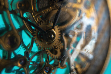 The view is close. Mechanism of a wristwatch. Gears, levers, springs and gems. Engraving and gold....