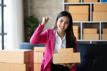 Smart Asian young woman SME working with a box at home. small business owner entrepreneur SME and delivery concept.