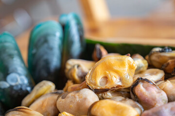 Box with a lot of fresh healthy seafood mussle with and without shell