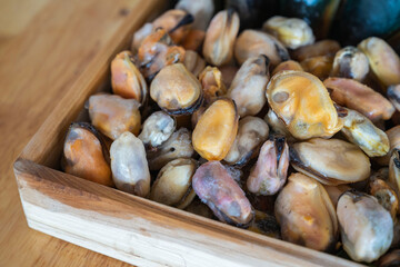 Box with a lot of fresh healthy seafood mussle with and without shell