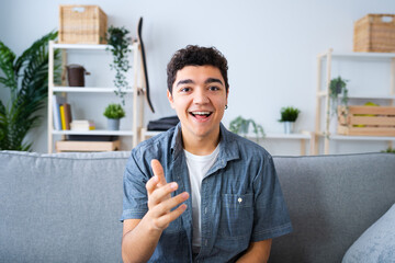Camera point of view of hispanic teenager boy live streaming or having video conference.