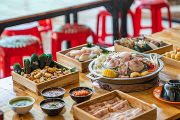 Wood Table with deliciouse seafood, shrimp, crab, mussle, pork saussage and vegetable in bbq grill...