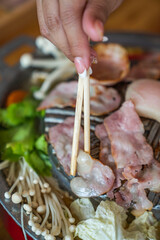 Closeup of grill with deliciouse seafood, shrimp, crab, mussle, pork sausage and vegetable on wood table in BBQ grill restaurant from thailand