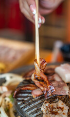 Closeup of grill with deliciouse seafood, shrimp, crab, mussle, pork sausage and vegetable on wood table in BBQ grill restaurant from thailand
