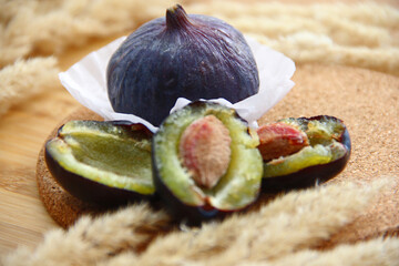 fresh figs and plum on a wooden table