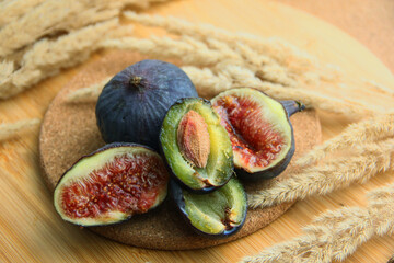 fresh figs and plum on a wooden table