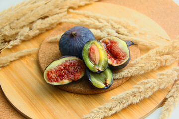 fresh figs and plum on a wooden table