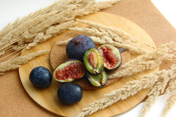 fresh figs and plum on a wooden table