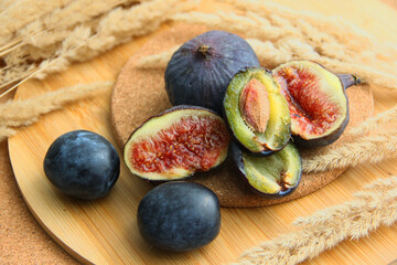 fresh figs and plum on a wooden table