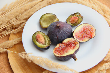 fresh figs and plum on a wooden table