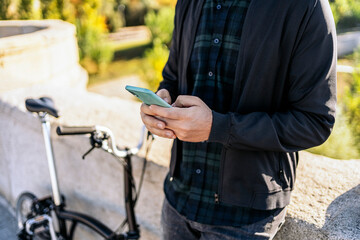 Man Standing and Using Phone