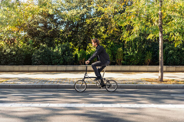 Obraz premium Man Riding Bike in Street