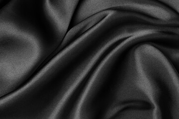 Fototapeta premium Black fabric texture background, wavy fabric slippery black color, luxury satin cloth texture.