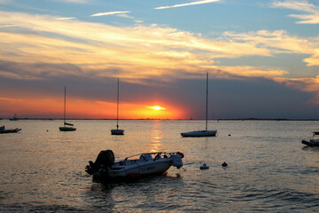 Sun setting over the Great South Bay looking over moored boats
