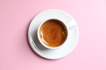 White cup of coffee espresso isolated on pink background
