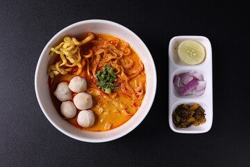 Khao Soi Thai Curry soup isolated in black background