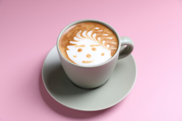 hot cappuccino with latte art isolated in pink background