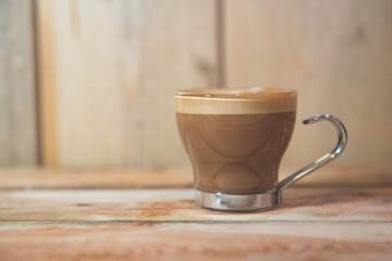 cup of coffee on wooden table