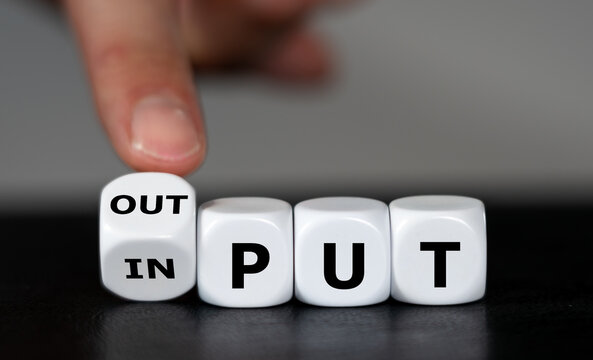 Hand turns dice and changes the word input to output.