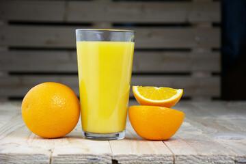 Oranges with a glass of orange juice