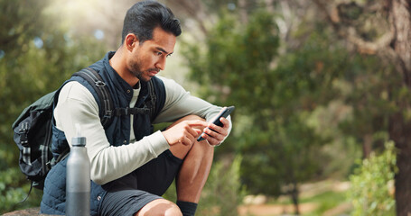 Phone, hiking and man in nature for a gps location, travel and freedom in mountains of Peru during a holiday. Young, thinking and Asian man with a mobile for communication while trekking in a forest