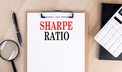 SHARE RATIO text on a clipboard on wooden background