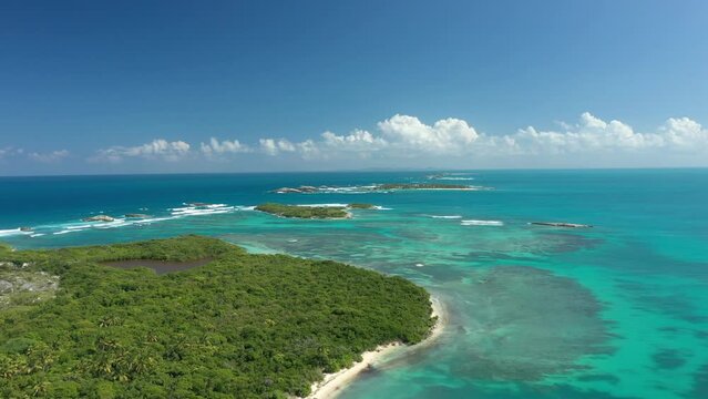 Aerial Drone footage over Cayo Icacos in Puerto Rico. A caribbean tropical island with boats, beach and trees
