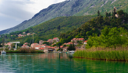 Fototapeta na wymiar sailing boats at anchor berthed in small river at Kolomac Dubrovnik Croatian small touristic town