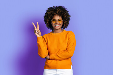 Cool stylish young black woman posing on purple