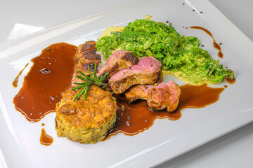 roast venison pink roasted on savoy cabbage vegetables and potato chestnut taler 