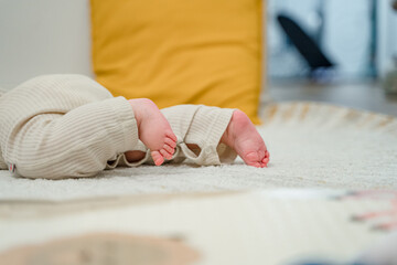 The legs of a small child on the carpet