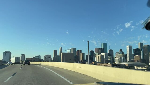 Drive on the I45 exit to reveal the Houston Downtown at Sunset. Exit from Texas 59 to Tx 288. Drive car passing downtown Houston Texas. Drive a right lane with Houston Downtown scene in the background