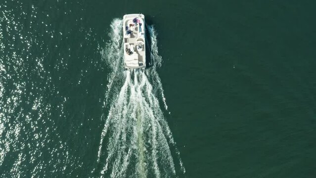 Aerial Top Down, Pontoon Boat With Family And Friends Relaxing Sailing On Lake During Summer Vacation