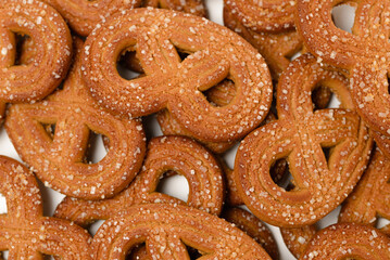 Food background with shaped rye cookies or pretzels  with crystal sugar top view