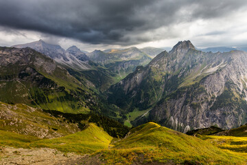 Mountain landscape with clouds and meadows in Allgau Alps, Germany