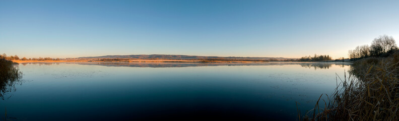 Panorama lake view in sunrise time .Sunrise at the lake