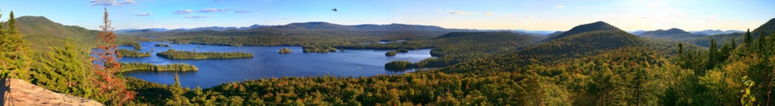 Blue Mountain Lake panorama with sightseeing floatplane above, Adirondack Park, NY, USA