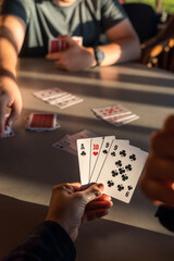 A person looking at his cards while thinking about the next move