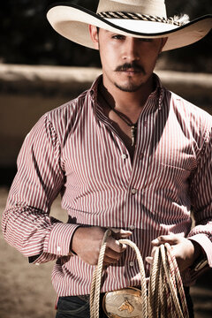 Portrait of a professional Mexican cowboy, holding his lasso in Hacienda San Andres, Estado de Mexico, Mexico.